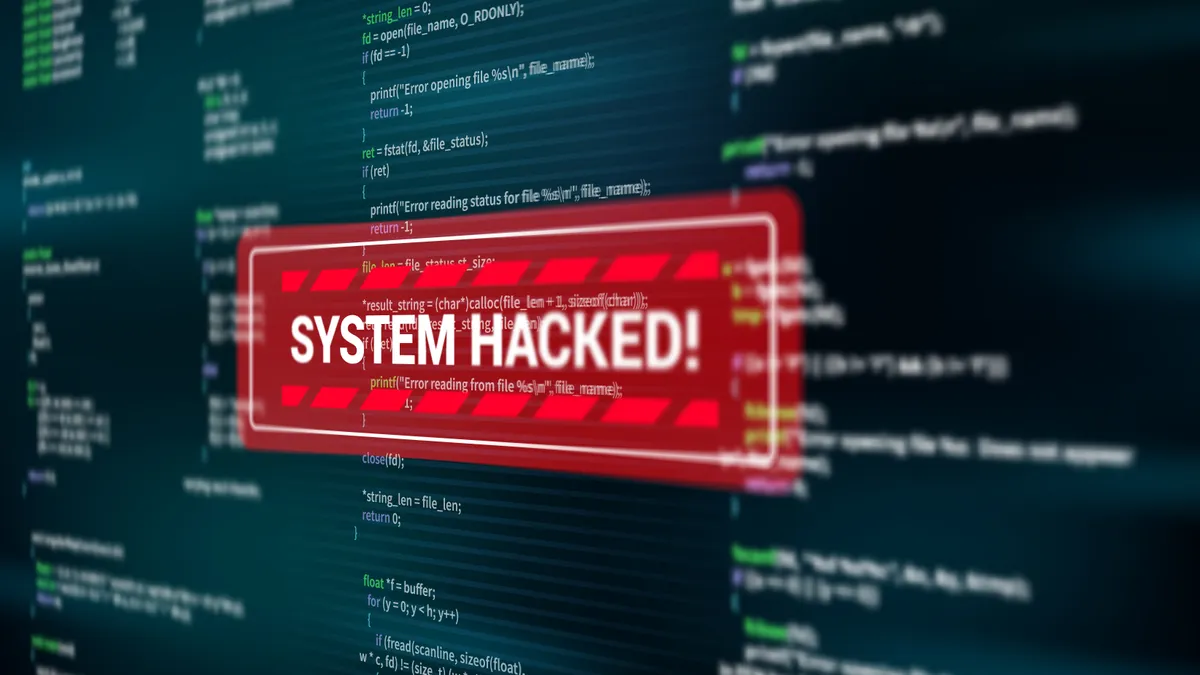 "System hacked" warning alert message displayed on a screen.