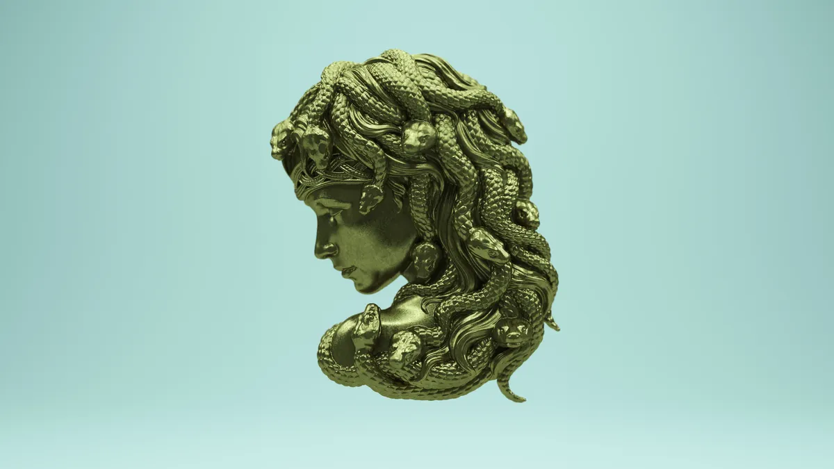 A bronze depiction of ancient god Medusa with snakes in her hair on a teal background.