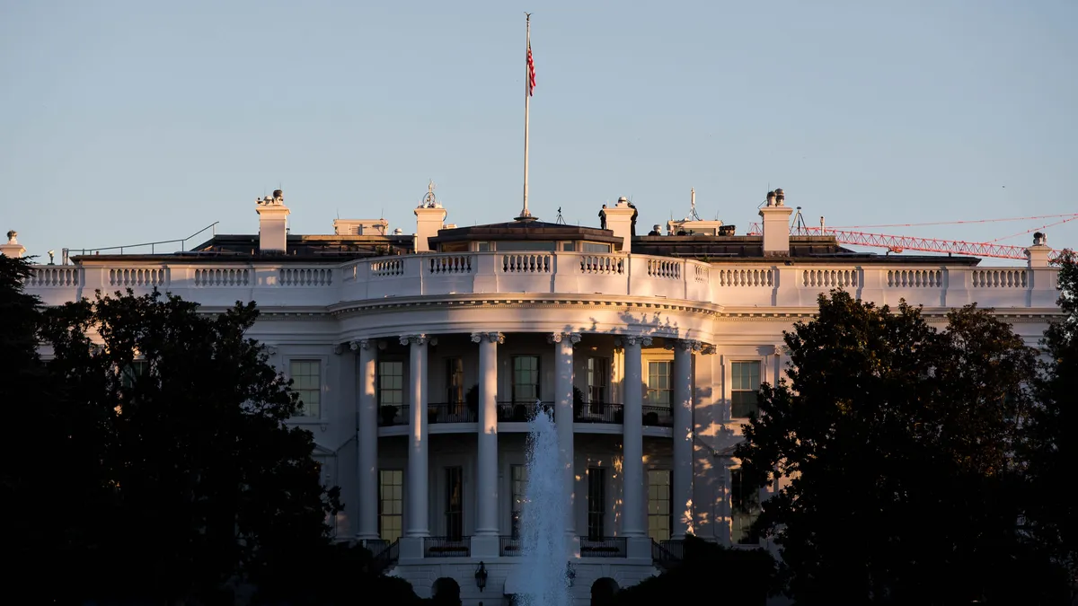 The sun rises near the White House in Washington, DC.