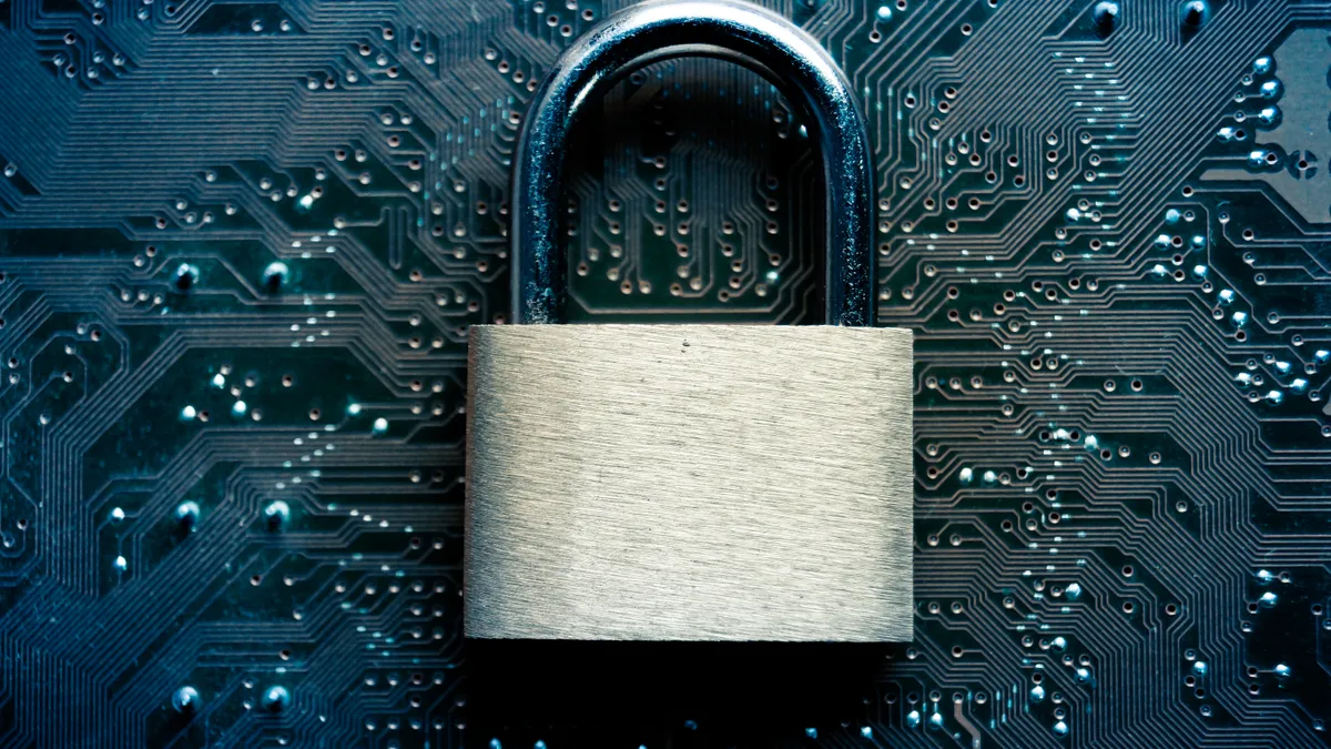 An illustration of cyber security, showing a padlock over a circuit board.