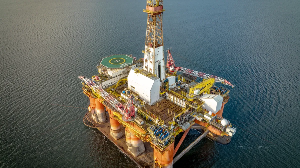 A drilling rig and platform used in the oil and gas industry for offshore fuel exploration.