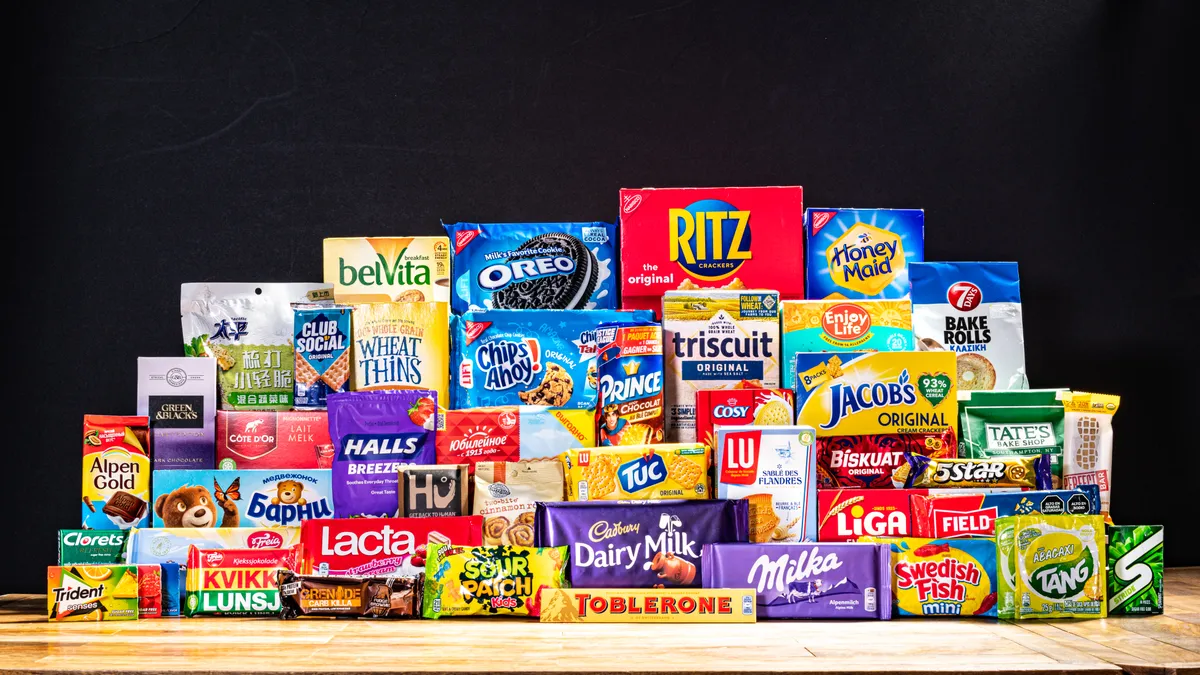 A stack of snack food packages from Mondelez International, including Wheat Thins, Oreos, Ritz and Sour Patch kids.