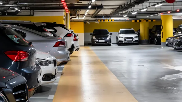 Cars are parked in a multistory garage.