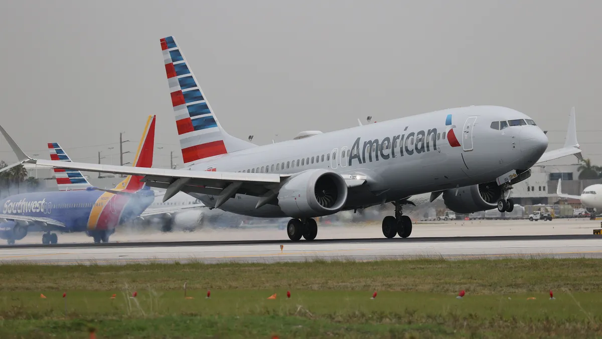 American Airlines jet taking off from an airport runway.
