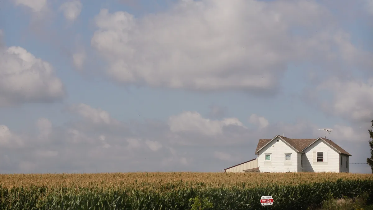 Corn field and a house.