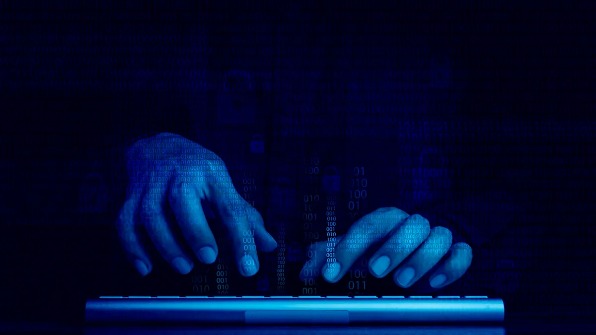 Digital code data numbers and secure lock icons on hacker's hands working with keyboard computer on dark blue tone background.