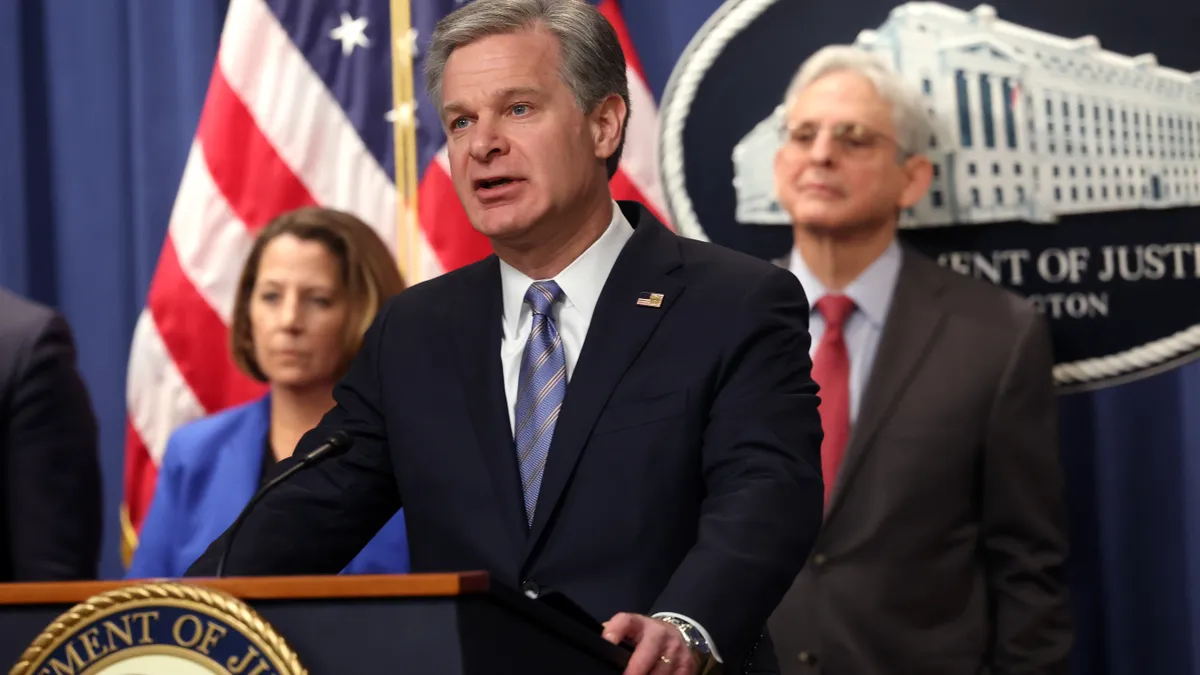 An image of Federal Bureau of Investigation Director Christopher Wray at a press conference.
